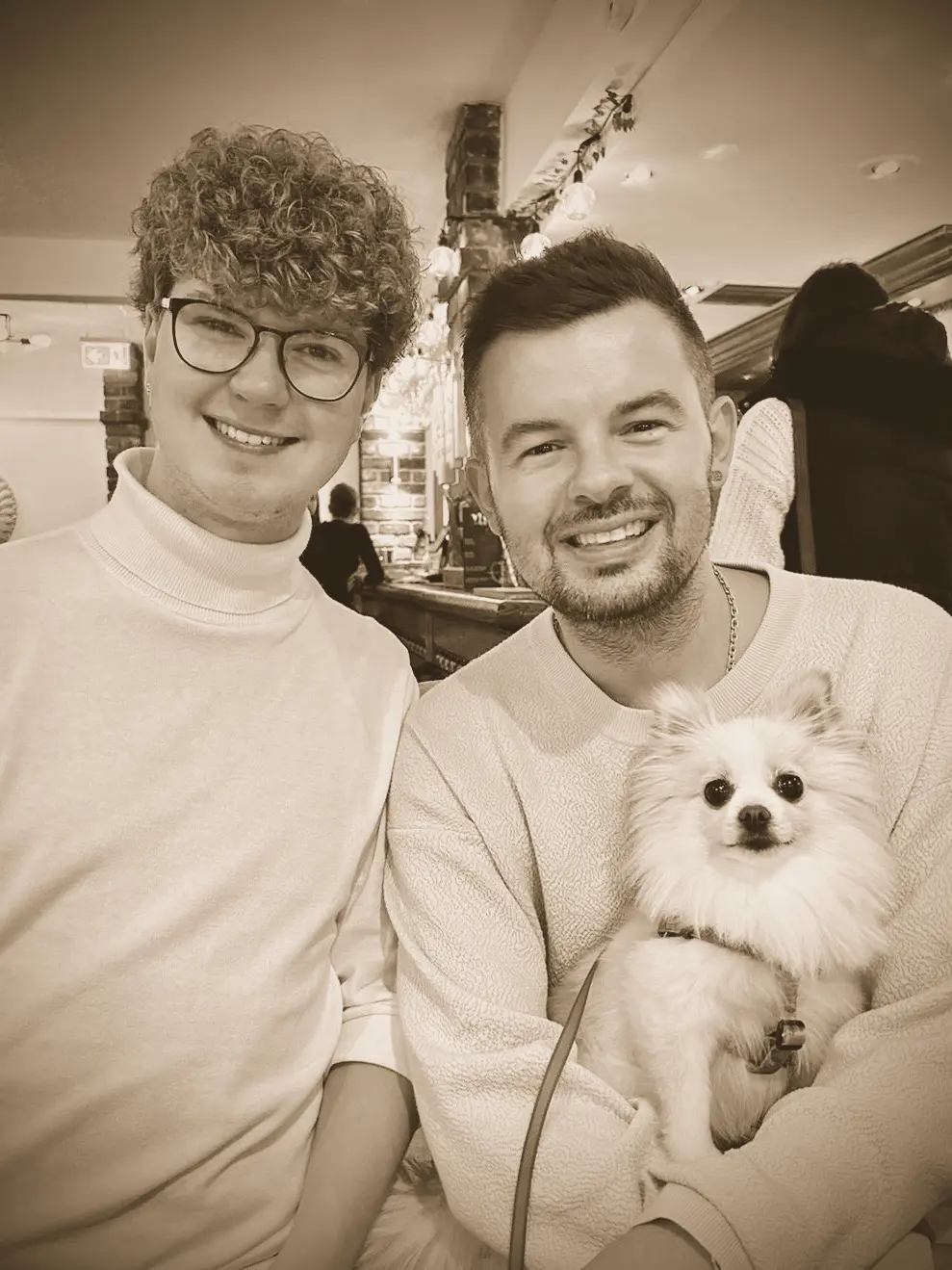 Tom and Dan with Dolly the Pomeranian in a café